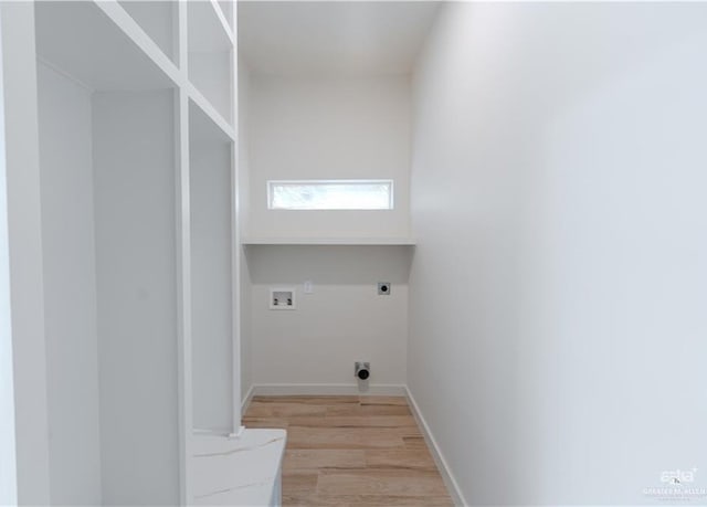 washroom with hookup for an electric dryer, light hardwood / wood-style floors, and washer hookup