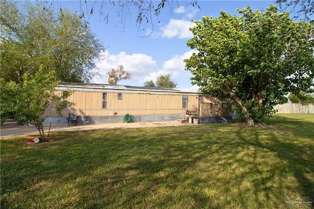 back of property with a yard and a patio area