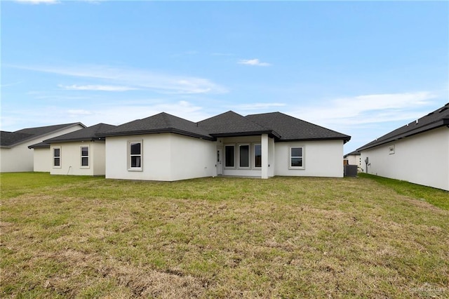 905 Magnolia St, Mission, TX 78574 - rear view of house with central AC, stucco siding, and a lawn