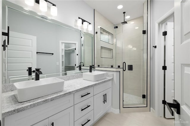 905 Magnolia St, Mission, TX 78574 - full bath with a shower stall, double vanity, tile patterned floors, and recessed lighting