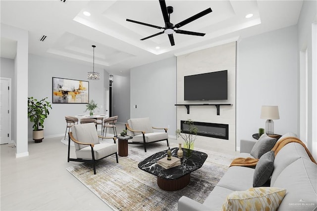 905 Magnolia St, Mission, TX 78574 - living room with a tray ceiling, recessed lighting, a ceiling fan, a fireplace, and baseboards