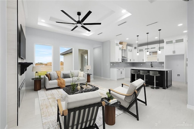 905 Magnolia St, Mission, TX 78574 - living area featuring a raised ceiling, recessed lighting, a ceiling fan, and baseboards