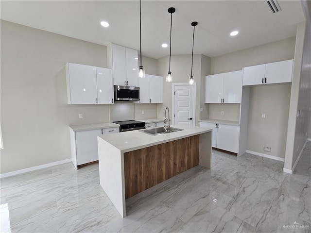 kitchen with a center island with sink, sink, range with electric cooktop, and white cabinets