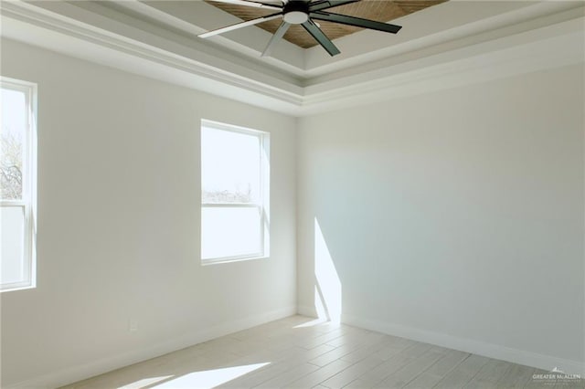 unfurnished room with light wood finished floors, a ceiling fan, and baseboards