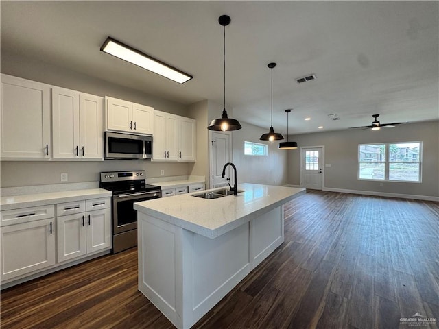 1604 Monterrey Cir, Brownsville, TX 78526 - kitchen with appliances with stainless steel finishes, dark wood-style floors, white cabinetry, ceiling fan, and recessed lighting
