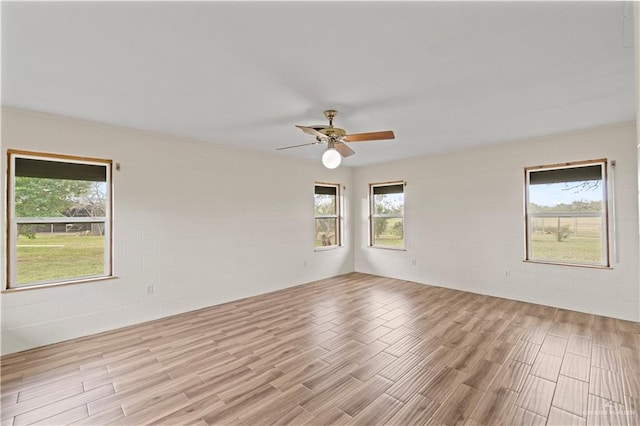 spare room with light hardwood / wood-style floors and ceiling fan