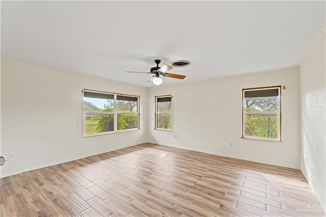 empty room featuring ceiling fan and light hardwood / wood-style flooring