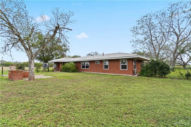 rear view of house with a yard