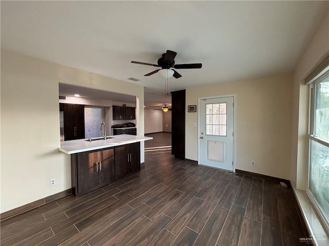 1060 Timothy St, San Benito, TX 78586 - kitchen with a ceiling fan, dark wood-style floors, light countertops, and dark brown cabinets