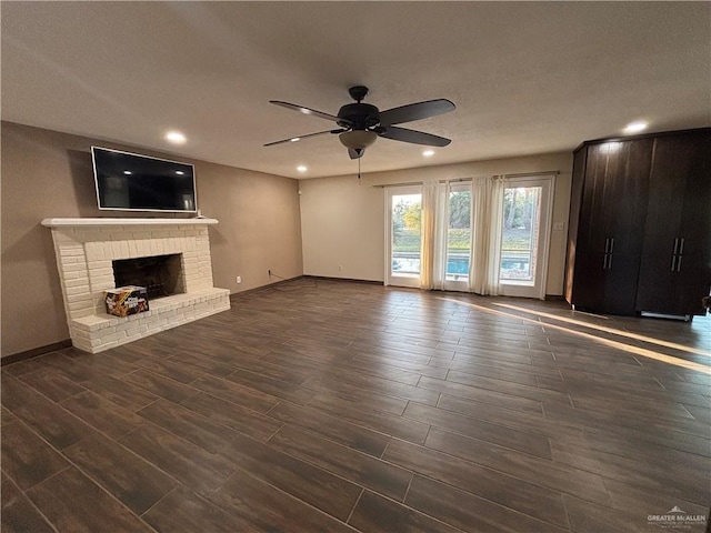 1060 Timothy St, San Benito, TX 78586 - unfurnished living room featuring a ceiling fan, recessed lighting, dark wood-type flooring, and a fireplace