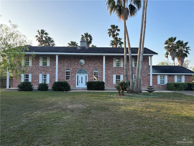 1060 Timothy St, San Benito, TX 78586 - neoclassical / greek revival house with a front yard and brick siding