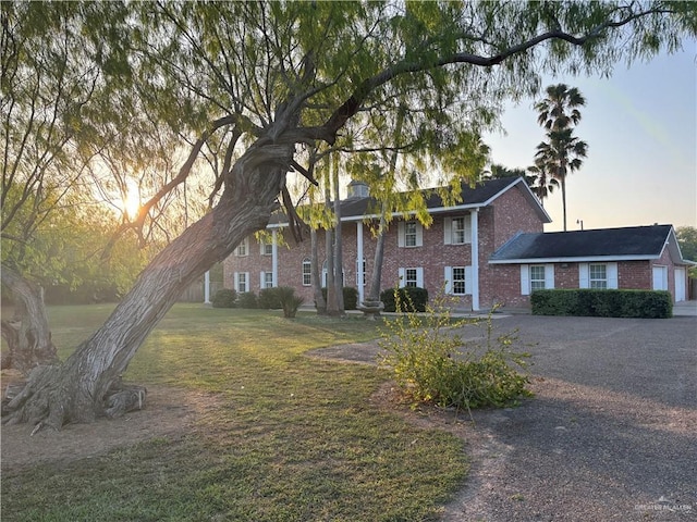 1060 Timothy St, San Benito, TX 78586 - neoclassical home with brick siding and a front yard