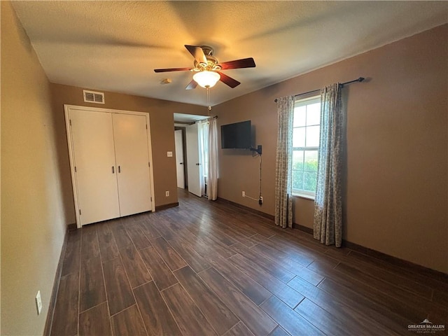 1060 Timothy St, San Benito, TX 78586 - unfurnished bedroom featuring dark wood-type flooring and a ceiling fan