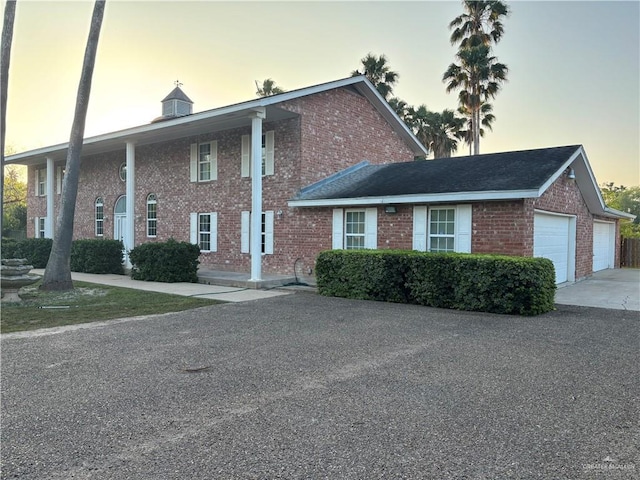 1060 Timothy St, San Benito, TX 78586 - neoclassical / greek revival house featuring brick siding and a garage