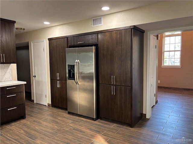 1060 Timothy St, San Benito, TX 78586 - kitchen with stainless steel fridge with ice dispenser, wood finish floors, dark brown cabinetry, light countertops, and recessed lighting