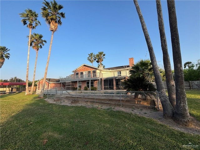 1060 Timothy St, San Benito, TX 78586 - back of house featuring a fenced backyard, a chimney, and a balcony