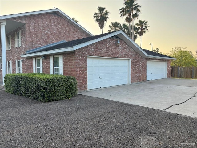 1060 Timothy St, San Benito, TX 78586 - view of property exterior with a garage, driveway, and brick siding