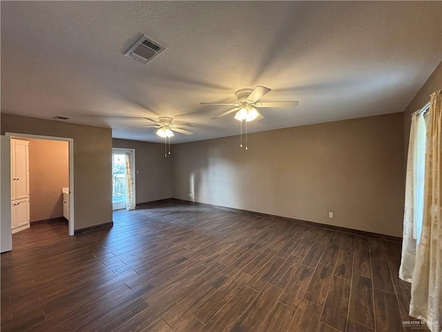 1060 Timothy St, San Benito, TX 78586 - spare room featuring ceiling fan, dark wood-type flooring, and a textured ceiling