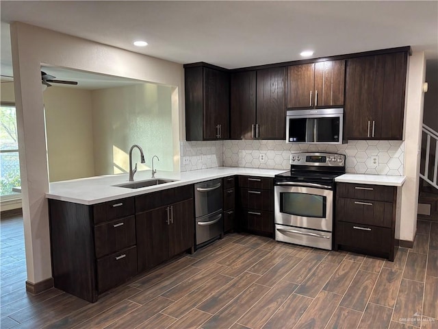 1060 Timothy St, San Benito, TX 78586 - kitchen featuring stainless steel appliances, light countertops, dark wood finished floors, and recessed lighting