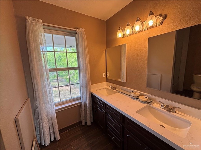 1060 Timothy St, San Benito, TX 78586 - full bath featuring double vanity, wood finished floors, and a textured wall