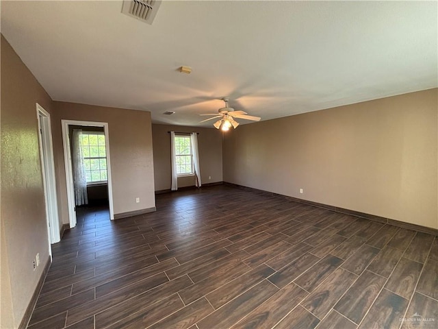 1060 Timothy St, San Benito, TX 78586 - empty room with dark wood-style flooring and a ceiling fan