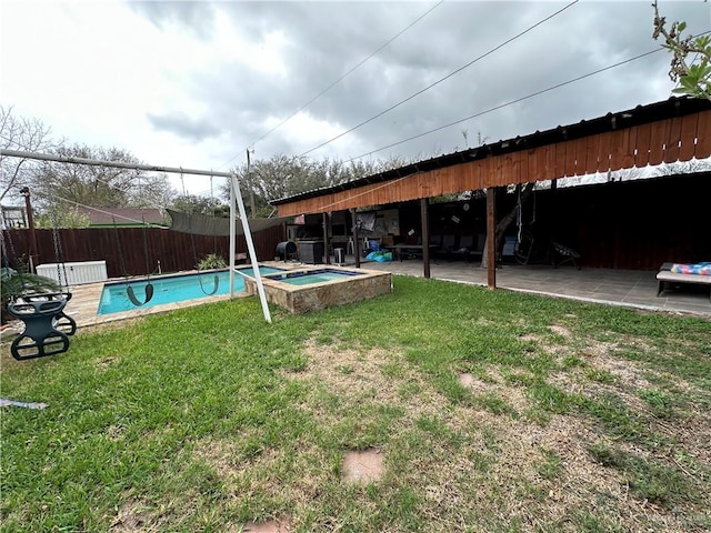 view of yard featuring a pool with hot tub