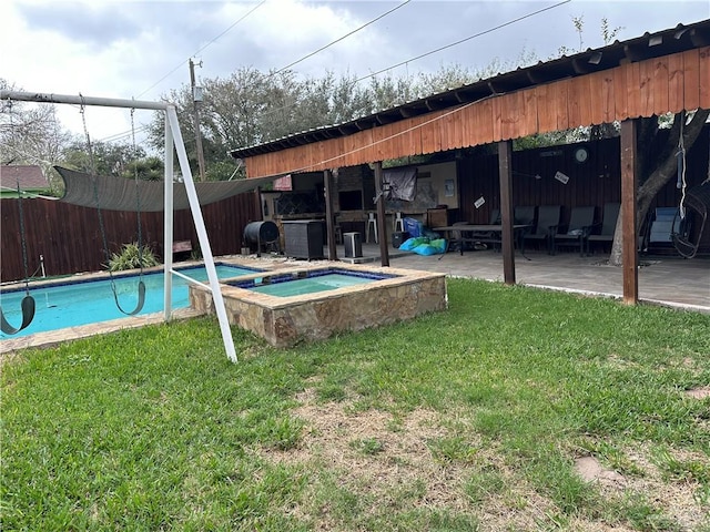 view of swimming pool with a lawn, grilling area, an in ground hot tub, and a patio