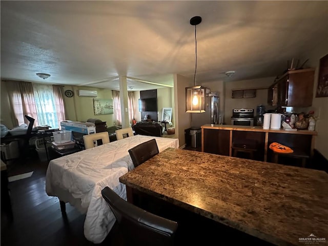 dining room with dark hardwood / wood-style flooring and an AC wall unit