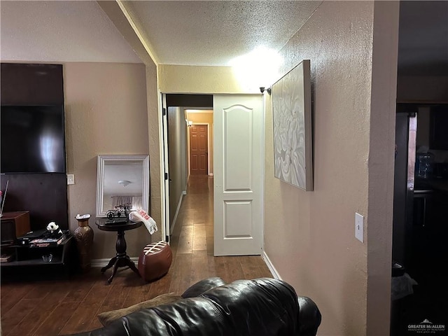 living room featuring hardwood / wood-style floors and a textured ceiling