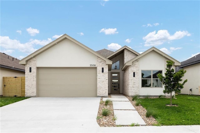 3508 E Kidd Ave, Edinburg, TX 78542 - view of front of home with an attached garage, driveway, and stucco siding