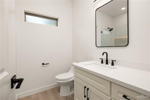 3508 E Kidd Ave, Edinburg, TX 78542 - full bath featuring toilet, vanity, wood finished floors, a shower, and baseboards