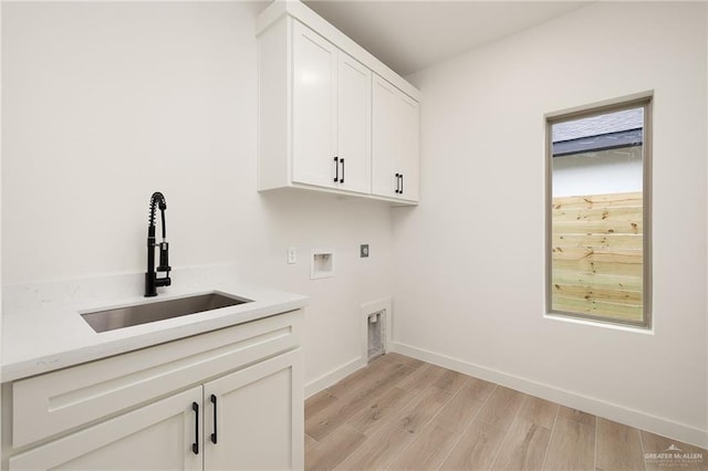 3508 E Kidd Ave, Edinburg, TX 78542 - clothes washing area featuring cabinet space, hookup for a washing machine, light wood finished floors, baseboards, and hookup for an electric dryer