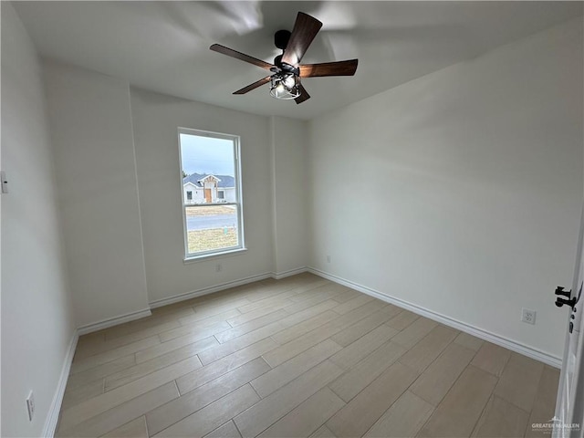 spare room featuring ceiling fan and light hardwood / wood-style floors