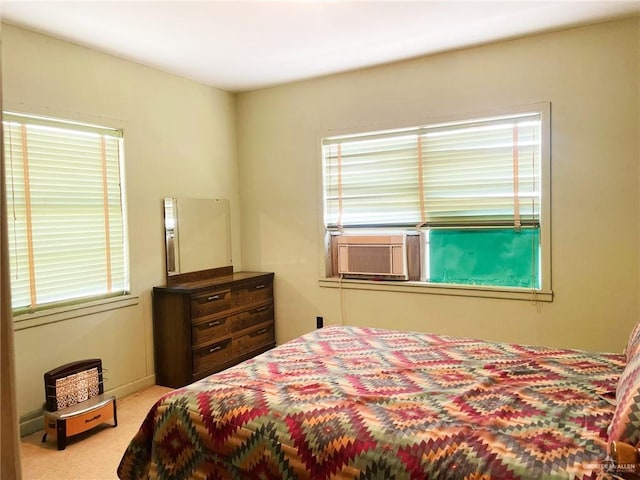 carpeted bedroom featuring multiple windows