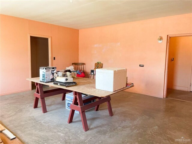 dining room featuring concrete flooring