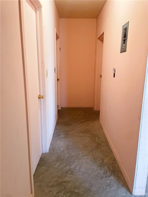 hallway with concrete flooring