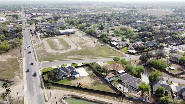 drone / aerial view with a residential view and a water view