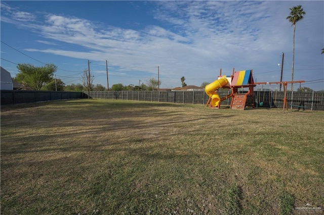 view of yard with playground community and fence