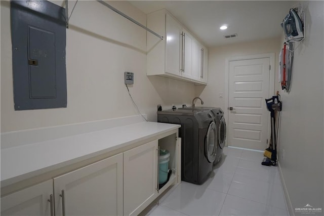 clothes washing area featuring visible vents, electric panel, washer and dryer, cabinet space, and light tile patterned floors