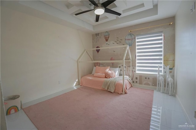 bedroom featuring baseboards, a raised ceiling, and ceiling fan