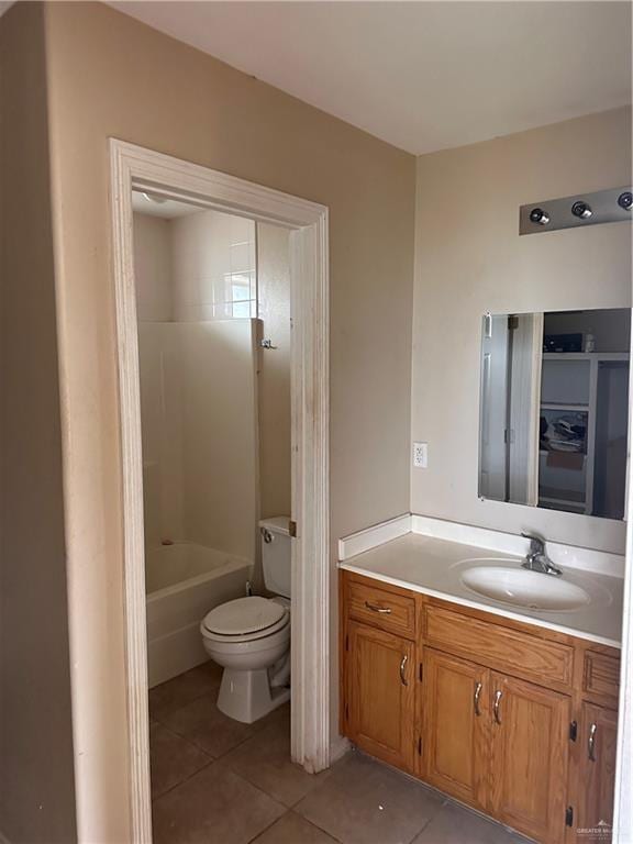 bathroom featuring tile patterned floors, vanity, and toilet