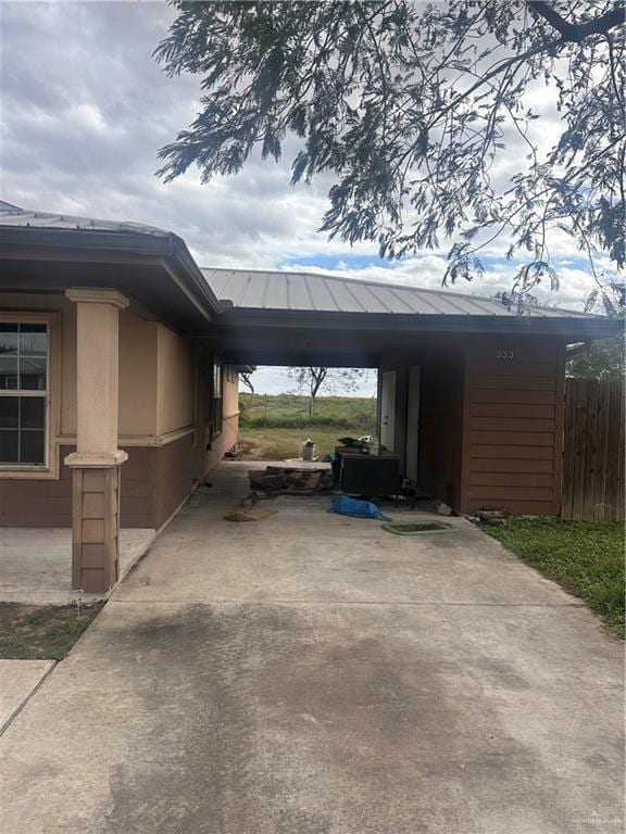 view of vehicle parking with a carport