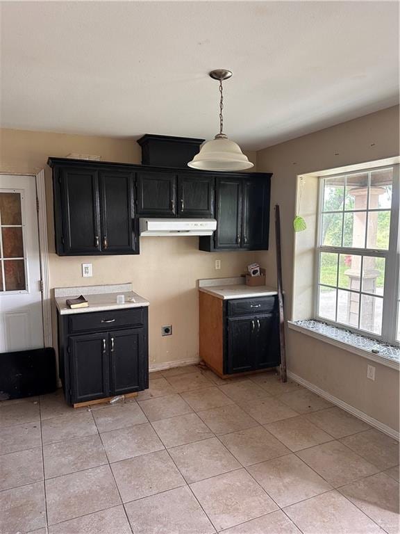 kitchen featuring light tile patterned floors and hanging light fixtures