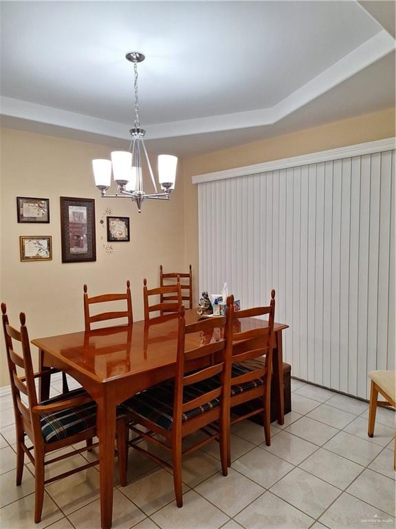 dining space with light tile patterned flooring and a notable chandelier