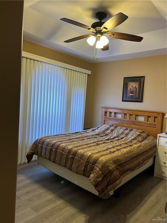 bedroom with ceiling fan and light hardwood / wood-style flooring