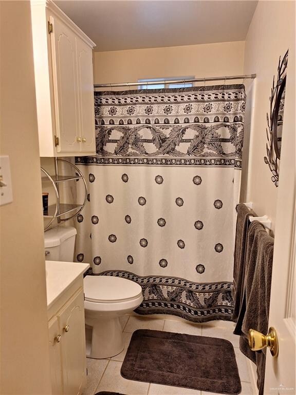 bathroom with tile patterned floors, toilet, and vanity