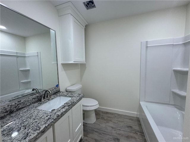 bathroom with vanity, toilet, and wood-type flooring