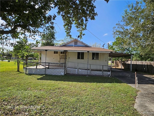 exterior space featuring covered porch, a yard, and a carport