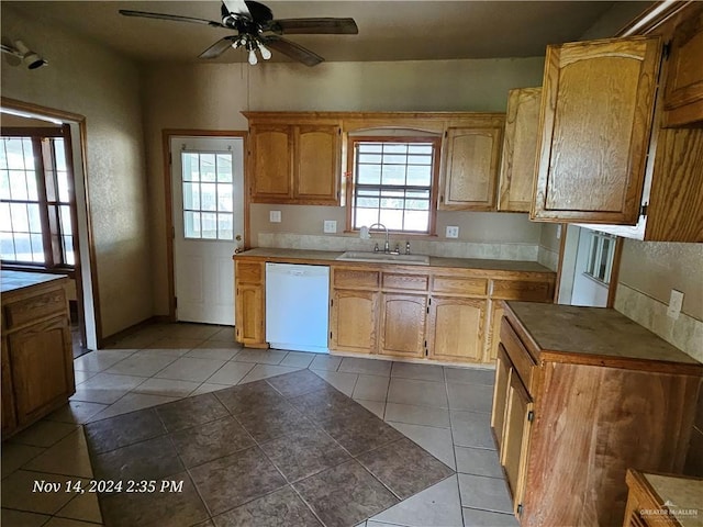 kitchen with light tile patterned floors, white dishwasher, ceiling fan, and sink