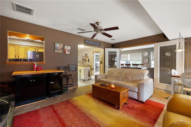 tiled living room featuring ceiling fan